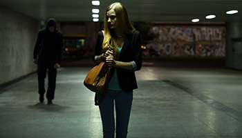 Woman walking in dark street